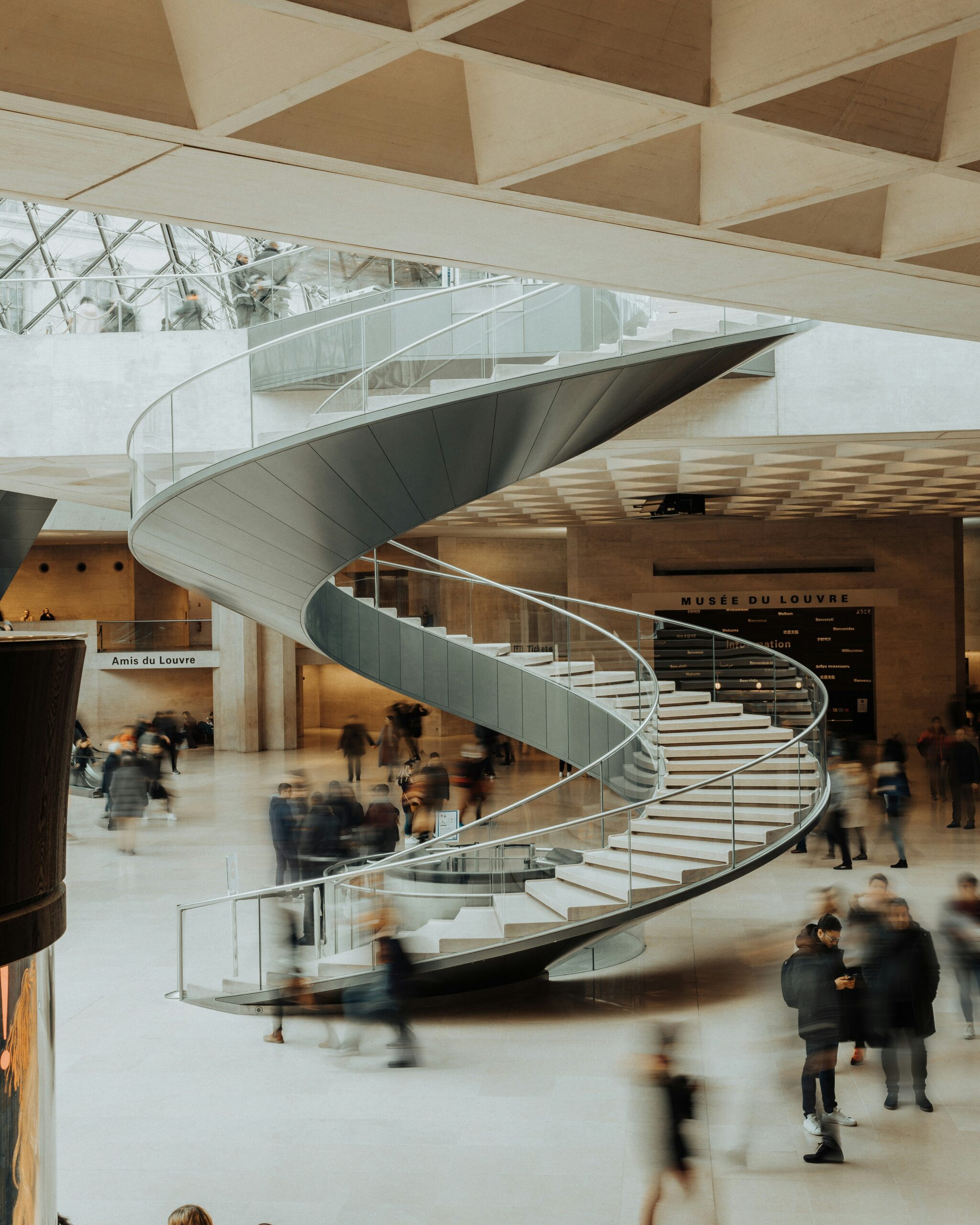 A sweeping spiral staircase in a grand institutional interior.