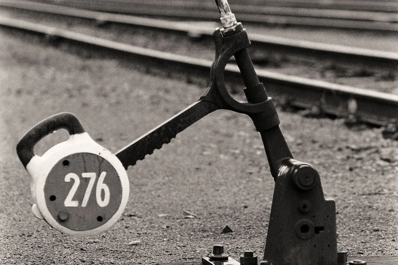 A railway point lever with a numbered counterweight beside the tracks.