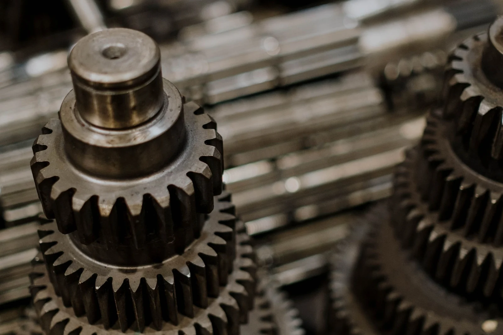 Steel gear wheels of different sizes stacked together, their teeth interlocking.