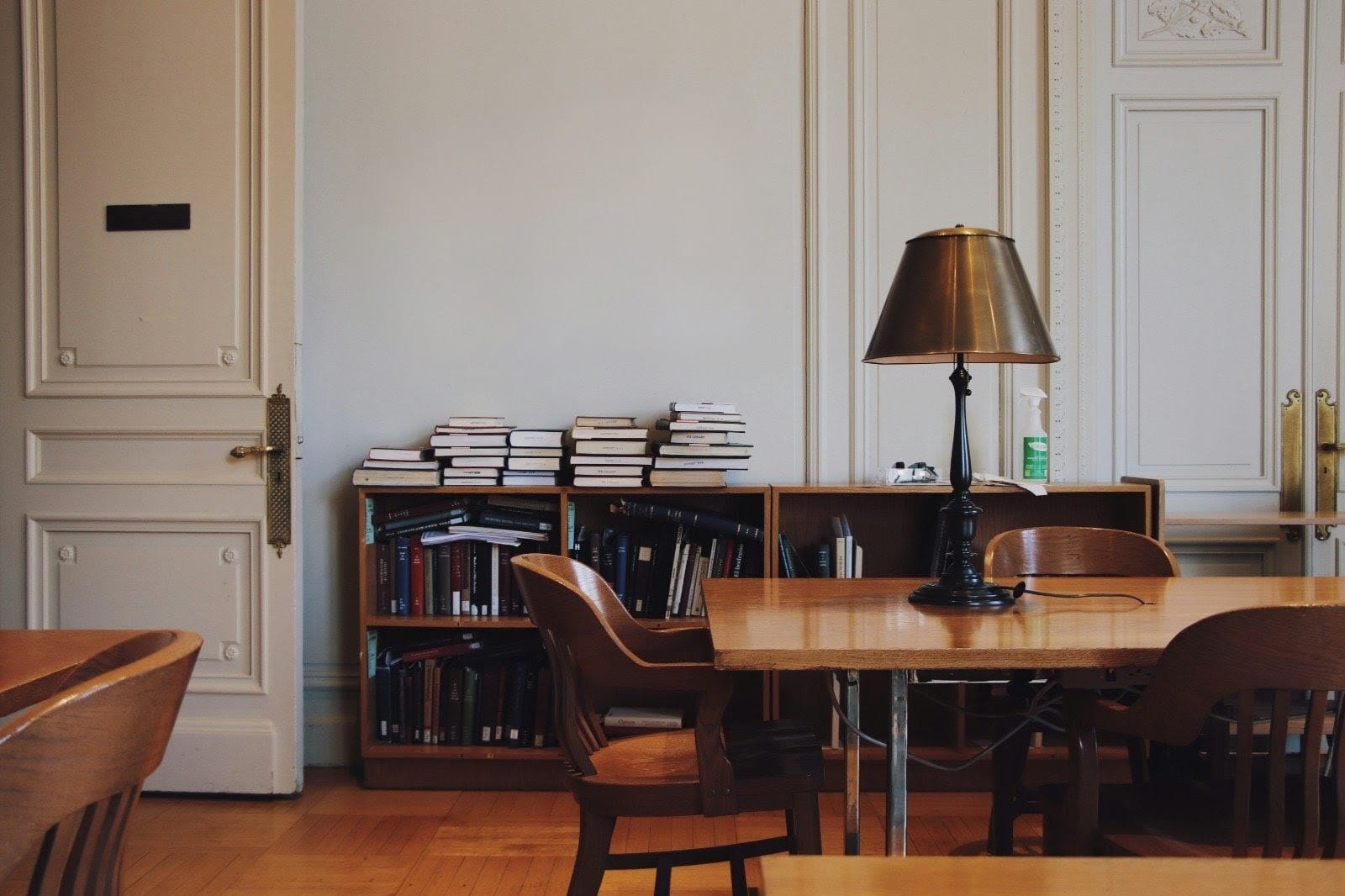 A sunlit lounge with leather chairs - quiet authority before a grand backdrop.
